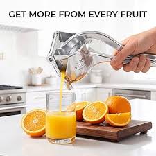 Stainless steel manual fruit juicer squeezing orange juice into glass