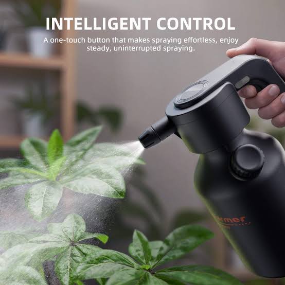 Manual clear spray bottle misting red flower on plant
