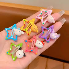 Cute star and animal snap hair clips in colorful designs held in hand