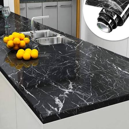 Black marble self-adhesive wallpaper applied on kitchen countertop